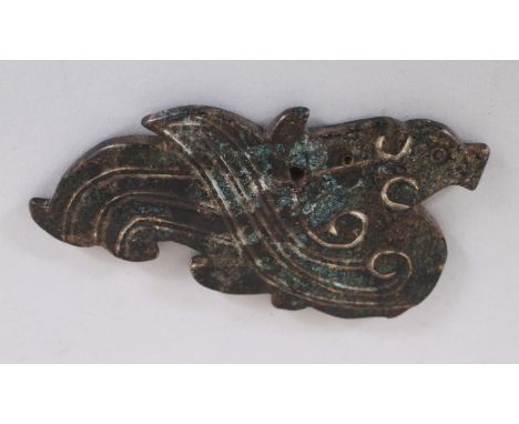 A CHINESE CARVED JADE-LIKE HARDSTONE TABLET OF A PHOENIX, in an archaic style, 9.6cm wide &amp; 5.3cm high.