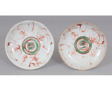 A SMALL PAIR OF 17TH CENTURY CHINESE PROVINCIAL PORCELAIN DISHES, decorated in iron -red and green enamel, each base unglazed