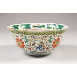 A CHINESE FAMILLE VERTE PORCELAIN BOWL, with indented rim, the sides painted with bird medallions