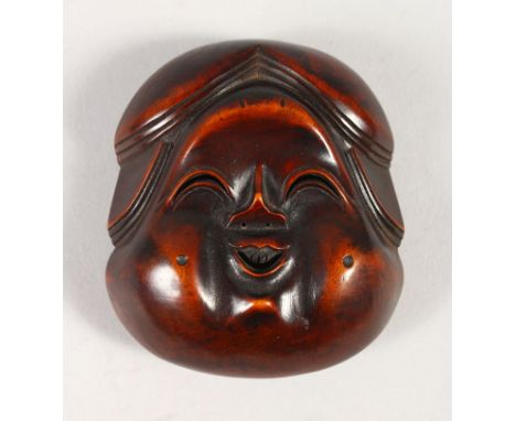 A JAPANESE LARGE CARVED BOXWOOD NETSUKE OF OKAME, Meiji period, artist signed to the rear,7cm high, 6.5cm wide.