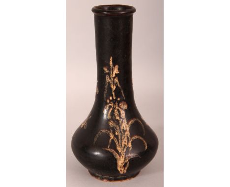 A SONG STYLE JIZHOU PAPERCUT CERAMIC VASE, the foliate decoration in ochre on a black ground, the base unglazed, 19cm high.