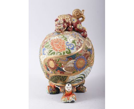 A LARGE JAPANESE SATSUMA SPHERE / BALL, heavily decorated with enamel, with a dog of foo sat upon the top, three feet formed 