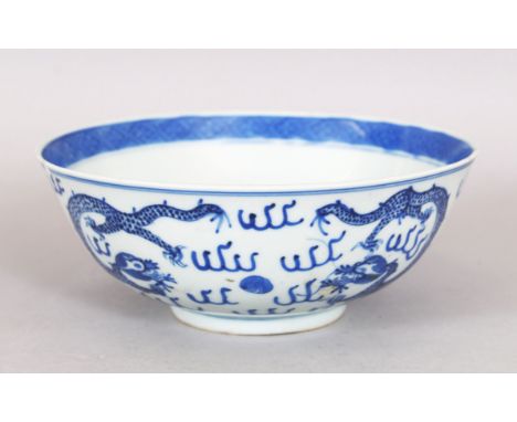 A 19TH CENTURY CHINESE BLUE &amp; WHITE PORCELAIN DRAGON BOWL, the base with a four-character Kangxi mark, 18cm diameter &amp