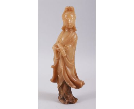 A CHINESE SOAPSTONE FIGURE OF GUANYING, modelled holding her scroll, 26cm high, 10cm wide.