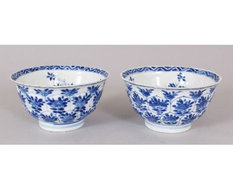 A PAIR CHINESE KANGXI PERIOD BLUE &amp; WHITE MOULDED PORCELAIN BOWLS, each base with a ding censer mark, 11cm diameter.