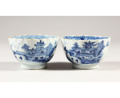 TWO 19th CENTURY CHINESE BLUE &amp; WHITE PORCELAIN TEA BOWLS, decorated with typical village scenes, and scroll and vine bor