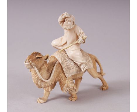 AN UNUSUAL JAPANESE CARVED IVORY OKIMONO, DEPICTING AN ARAB UPON A CAMEL, the man holding a stick in one hand with his other 