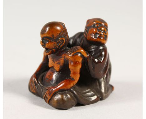 A VERY UNUSUAL JAPANESE BOXWOOD &amp; LACQUER NETSUKE, depicting the blind masseur, Meiji period, artist signed to base, 3.1c