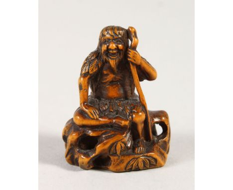 A JAPANESE BOXWOOD NETSUKE, depicting a seated sage upon a rock, Meiji period, artist signed to base, 4cm high, 3.2cm wide.