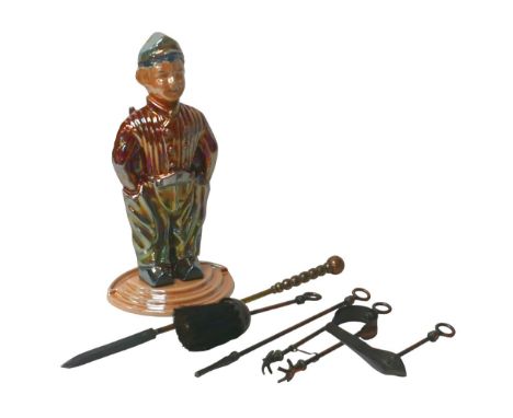 A retro fireside tool holder, in the form of a clogg wearing Dutchman, with metallic ceramic finish, 41cm high, together with