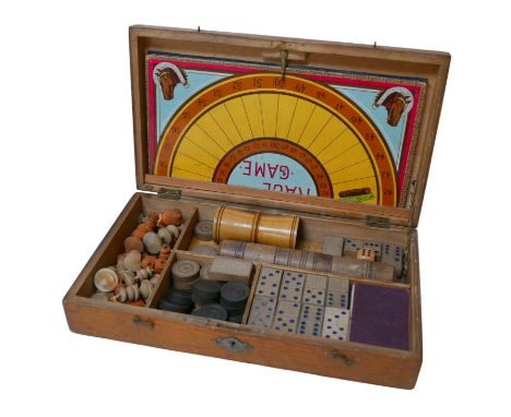 An early 20th century games compendium, to include chess, backgammon and dominoes, all within a pine case, 34 by 20 by 7cm hi