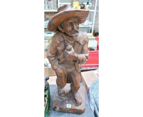 WOOD CARVING OF AN OLDER PERSON SMOKING A PIPE, APPROX 29" TALL