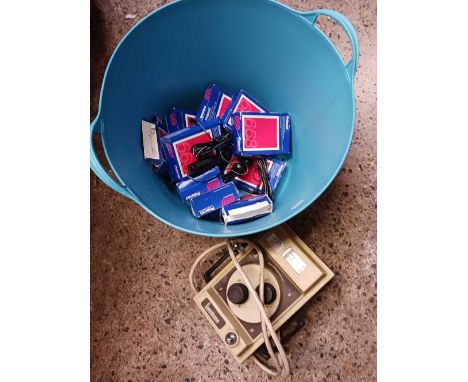 BLUE RUBBER TUB WITH POLAROID PACKS OF FILM, A LAMINEX MICRO 100 DUAL LENSE CAMERA