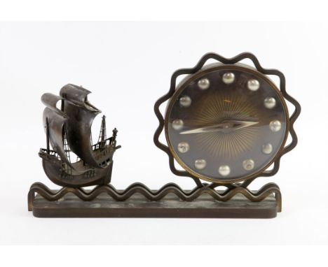 Art Deco Imhof cast metal mantel clock, with a ship sailing on a wavy sea away from the dial in the form of the sun, 15 jewel