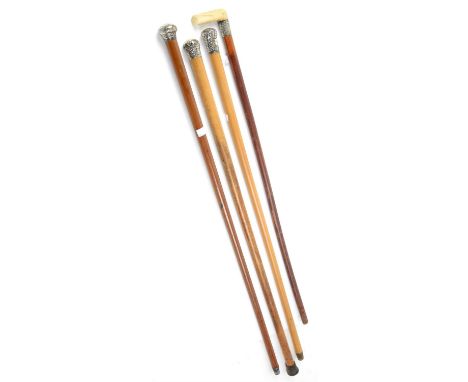 Silver topped walking cane London 1913, two other walking canes with embossed white metal tops and a walking stick with bone 