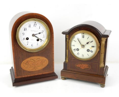 Early 20th century inlaid and crossbanded mahogany table clock, the arched case with inlaid butterfly motif enclosing an enam