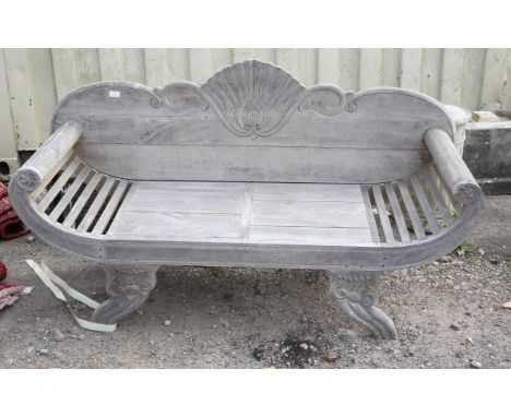Teak garden bench, in the Regency style with carved scroll and flowerhead design back, curved arms and carved legs, 153 cm wi