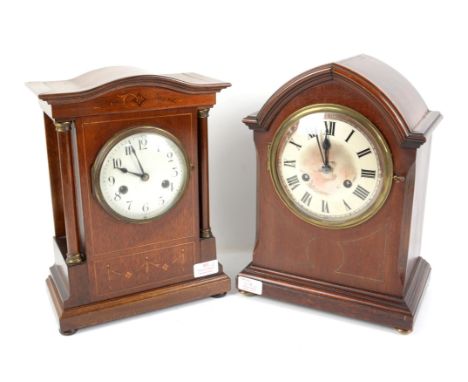 Early 20th century German inlaid mahogany mantel clock, the shaped top over columns enclosing a silvered dial, the twin train