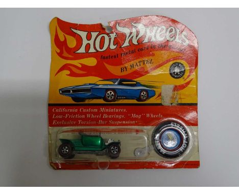 A MATTEL Hot Wheels Redline 1970 'Hot Heap' in metallic green partially unsealed on original card with button - G on G card (