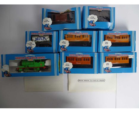 A group of HORNBY OO gauge 'Thomas the Tank Engine' series rolling stock including a 'Percy' engine and various coaches/wagon