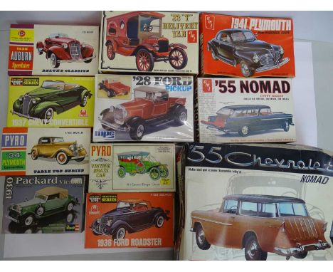 A group of unbuilt plastic kits in various scales by AMT, PYRO, REVELL etc - all American car examples - contents unchecked, 