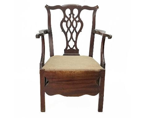 A George III provincial mahogany commode chair. In the country Chippendale manner, with a pierced vase splat, and scroll end 