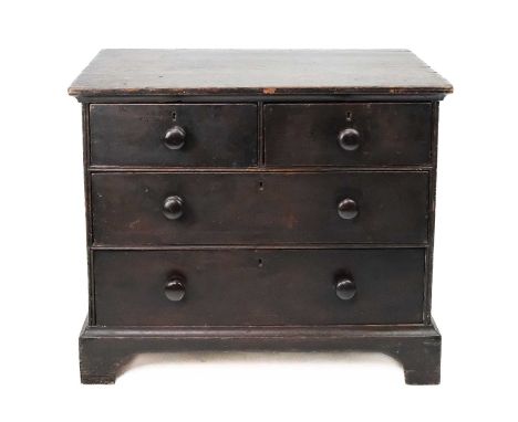 A late George III stained pine chest. Of two short and two long drawers, with turned handles and bracket feet, with a rich ma