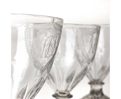A set of three Regency glass rummers. With monogrammed cartouches on lemon squeezer square bases, height 13.5cm (3).Two of th