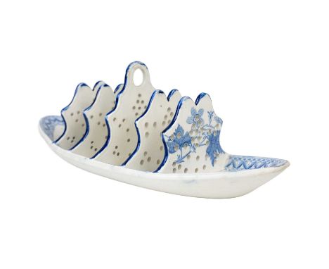 A Spode pearlware toastrack. Circa 1820, of boat shape, transfer printed in blue with a floral pattern, with pierced dividers