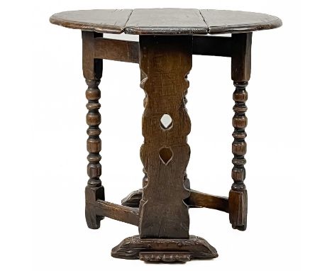 A 17th century style small oak gateleg table. Early 20th century, with heart shape pierced flattened end supports, on reel an