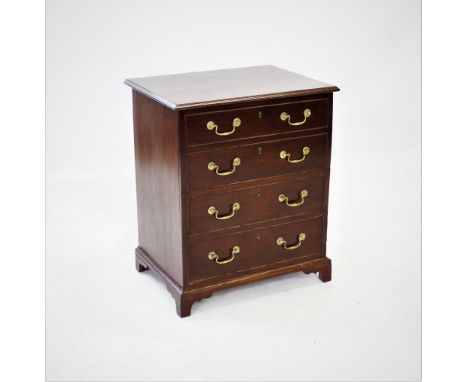 A George III mahogany commode chest, the rectangular hinged top above four faux drawers applied with brass swan neck swing ha
