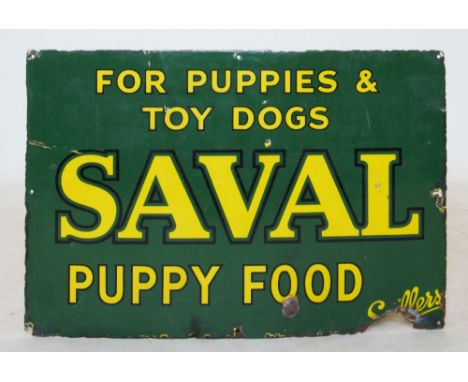 A vintage rectangular advertising enamel sign, 'For puppies and toy dogs Saval puppy food', yellow text on a green ground, 74