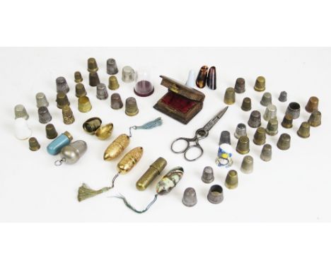 A collection of 19th century and later sewing items, to include, two yellow metal bobbin cases, each designed with foliate re