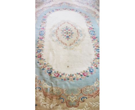 A large sculpted wool carpet, mid 20th century, the central floral medallion set within a scrolling floral border, floral and
