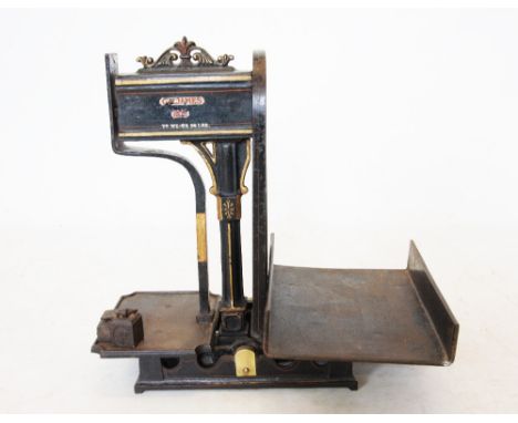 A set of early 20th century Japanned cast iron grocers scales by G.M James, Bath, with a cast central architectural column, a