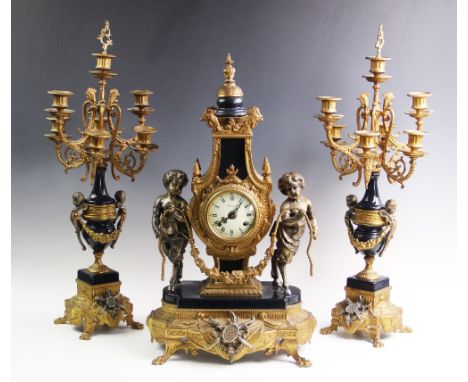 An Italian Brevettato Imperial gilt metal clock garniture, 20th century, the clock adorned with cast cherubs holding a rope s