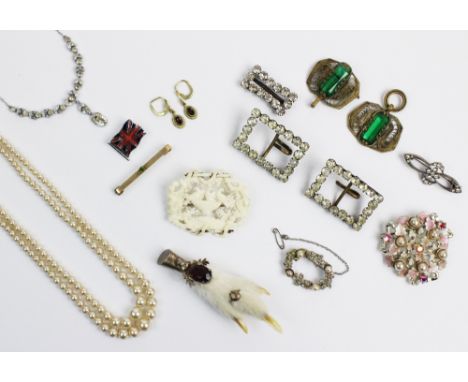 An assortment of vintage and costume jewellery, to include; a slave bangle, a green stone set buckle, assorted paste set buck