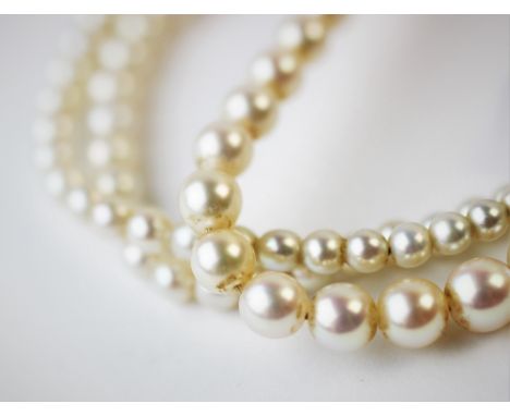 A single strand graduated cultured pearl necklace, with attached white metal clasp stamped '9ct', 43.5cm long For condition i