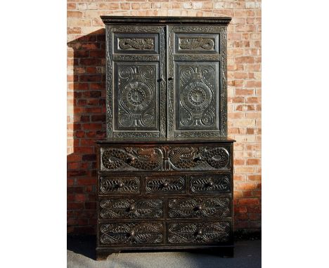 A late 19th century Welsh carved oak secretaire bookcase, with a Greek key pattern frieze above a pair of doors profusely car
