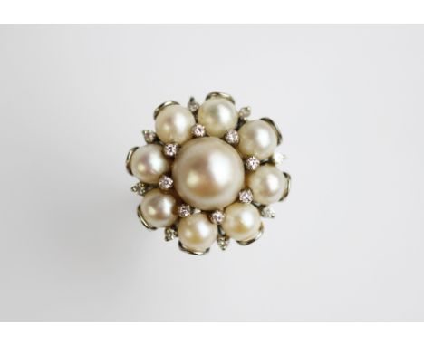 An untested pearl and diamond cluster dress ring, 1960's, designed as a central pearl within diamond set points surround with