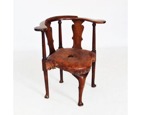 A George II mahogany corner elbow chair, the curved crest rail raised upon a pair of vase shaped splats and three ring turned