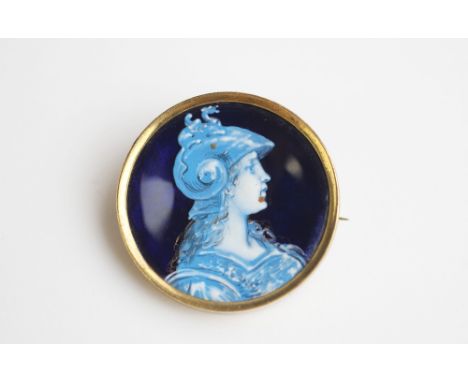 An enamel on copper Limoges style brooch depicting a female classical warrior, of circular form and depicting a profile portr
