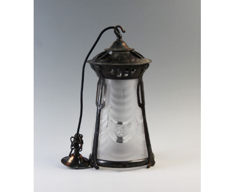 An early 20th century Art Nouveau pendant light fitting, the copper oxidised frame tapering to accommodate the frosted glass 