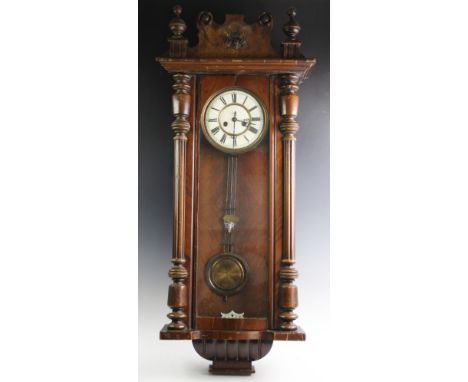 A Victorian walnut Vienna wall clock, the architectural case with turned fluted columns flanking the glazed door and 19cm whi