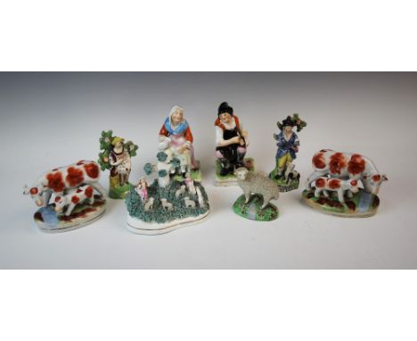 A group of Staffordshire flatback figures, 19th century and later, to include, a figural group of a gentleman and lady, model