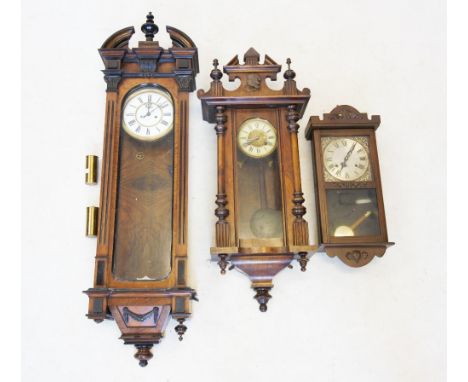 A Victorian walnut Vienna wall clock, the architectural pediment centred with a turned finial above an 18cm enamelled white d