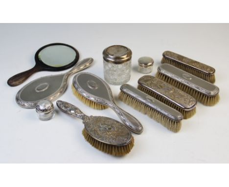 Three assorted silver topped dressing table jars and a selection of further dressing table wares to include brushes, hand mir