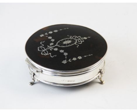 A silver pique work dressing table casket, Adie Brothers Birmingham 1922, the circular casket inlaid with a decorative floral