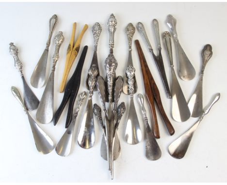 A collection of seventeen silver and white metal handled shoe horns, Victorian and later, each with Art Nouveau scroll detail