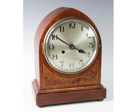 A 1920's Kienzle mahogany cased bracket clock, of lancet form with an 18cm silvered dial applied with Arabic numerals, the tw